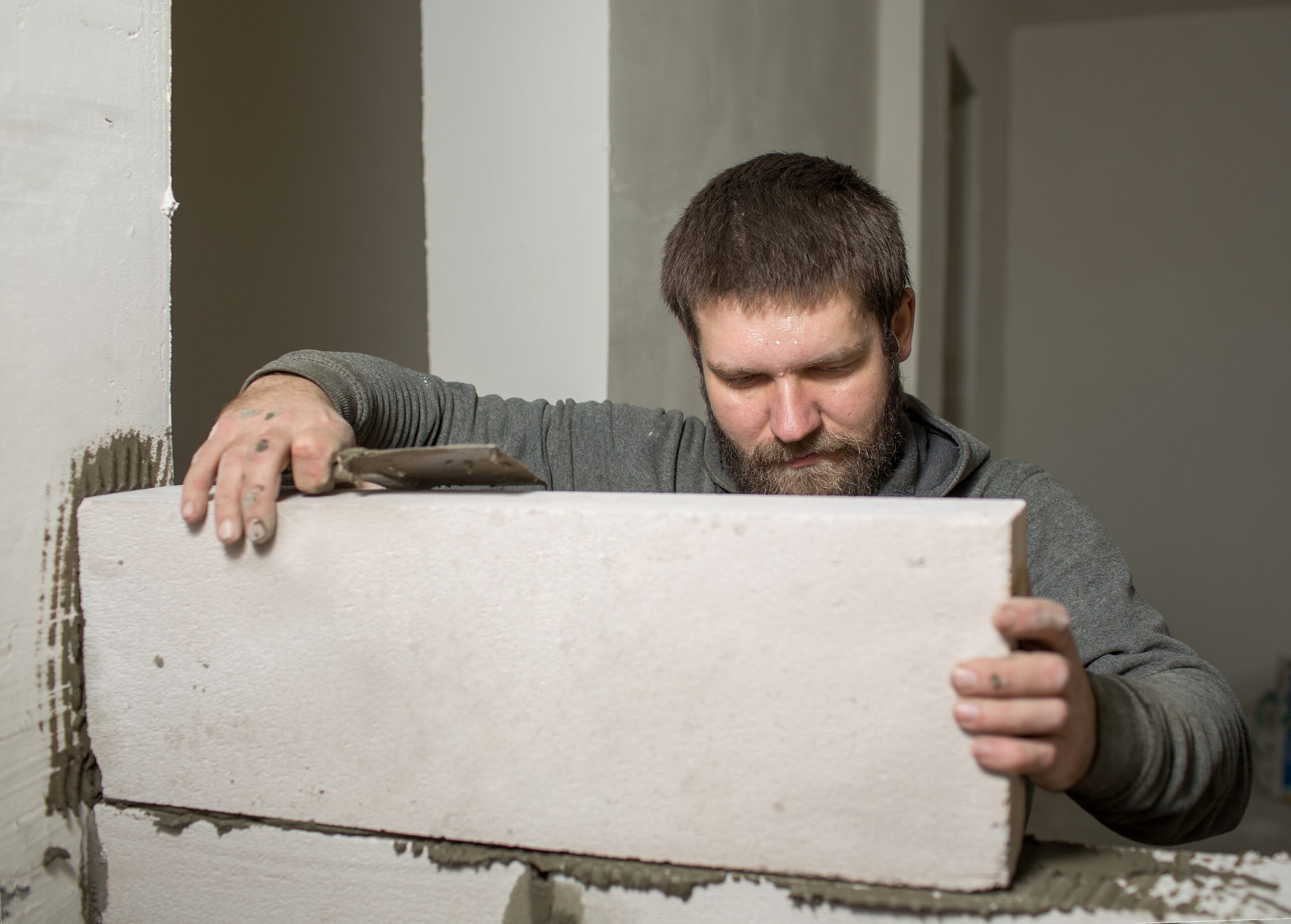 a male builder puts a wall of foam concrete blocks 2022 11 11 07 13 30 utc