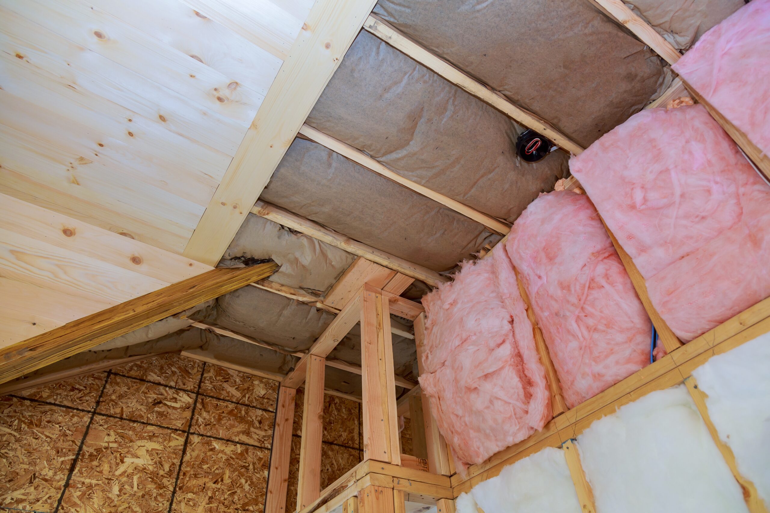 covering view of layers of pink fiberglass insulation cold barrier