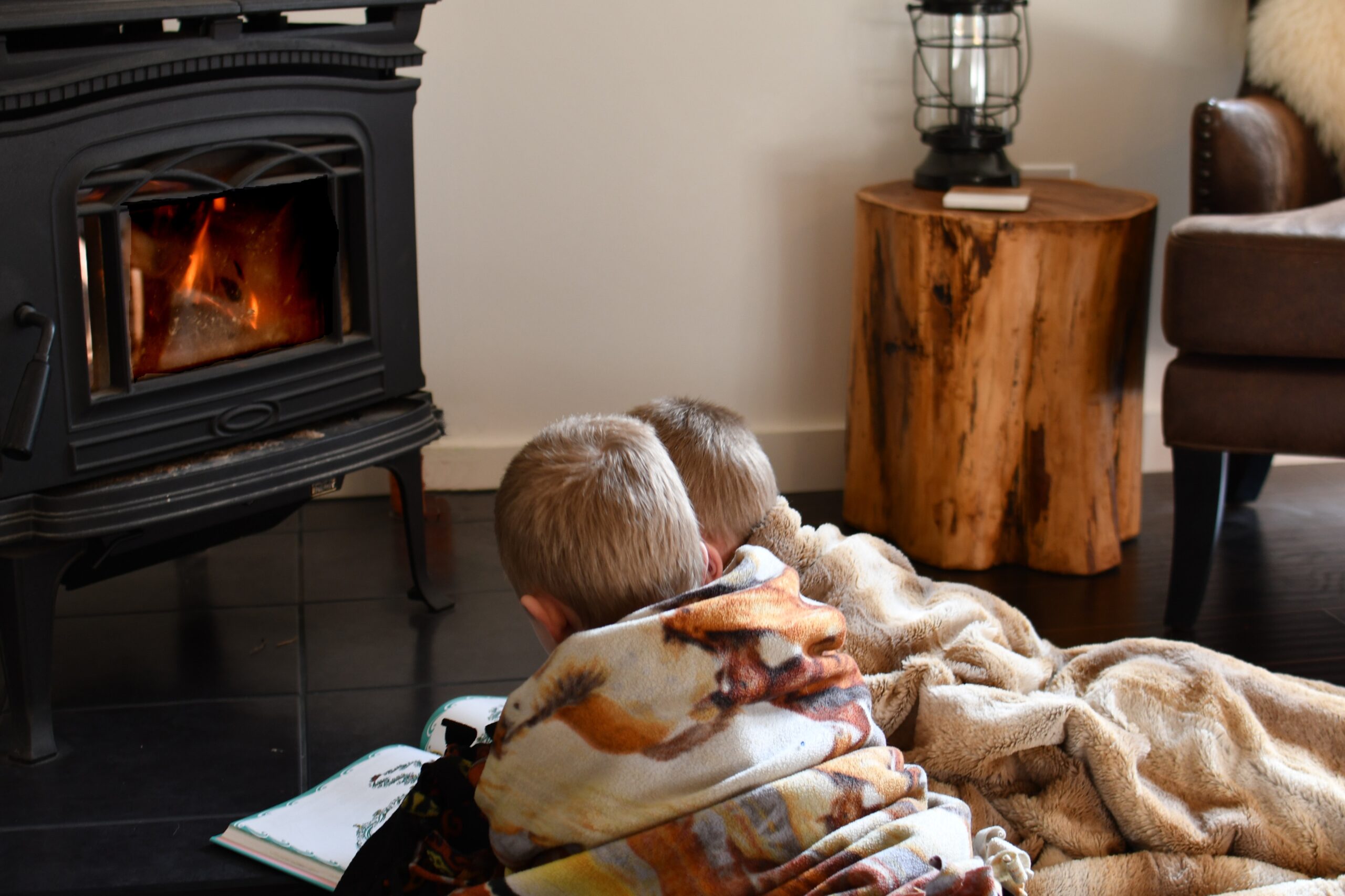 little boys reading by the wood stove fire while s 2022 11 14 03 36 21 utc