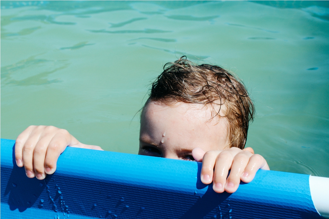 a five year old boy swims in the pool 2022 10 31 07 48 39 utc