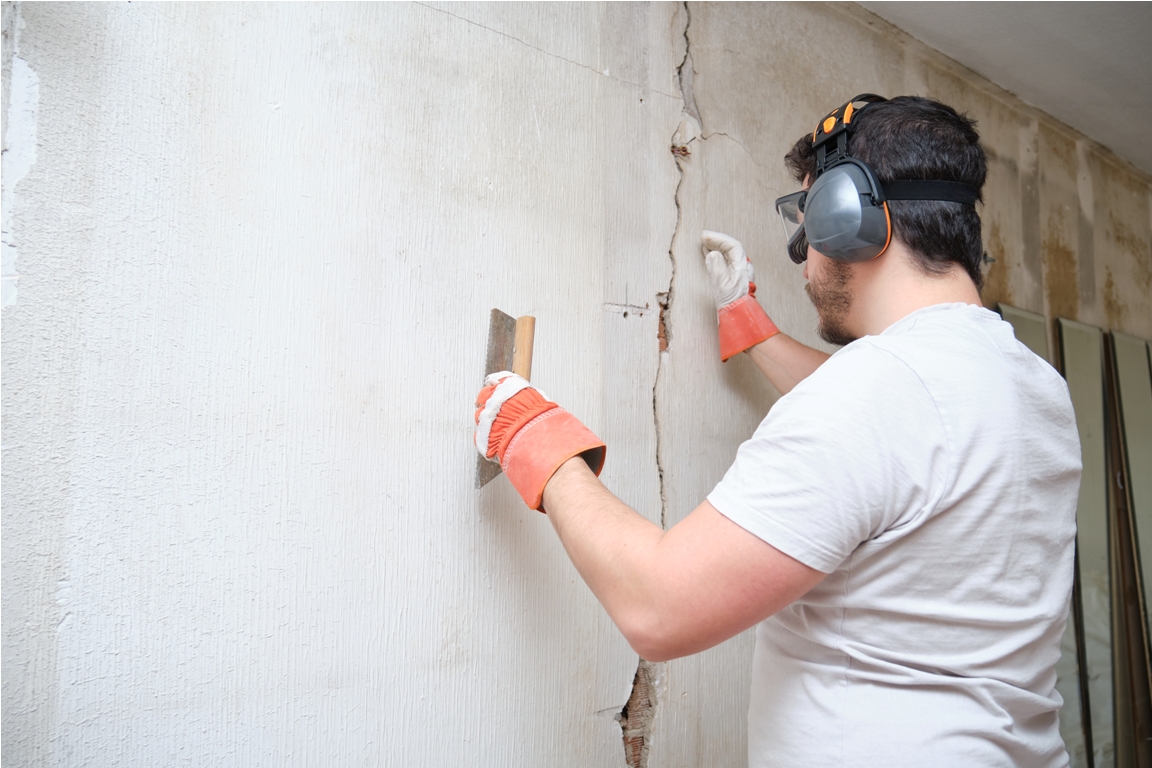 construction worker repairing a crack plastering 2022 08 16 22 37 24 utc