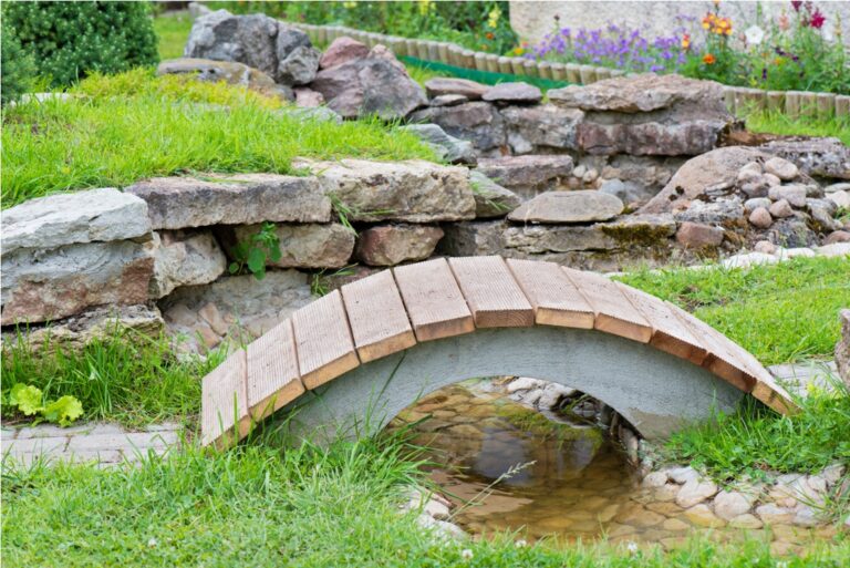 modern garden design, rock garden with pond and bridge in summer