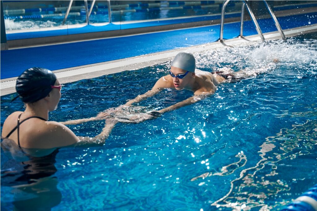coach helping male to swim in pool 2022 03 30 00 23 49 utc