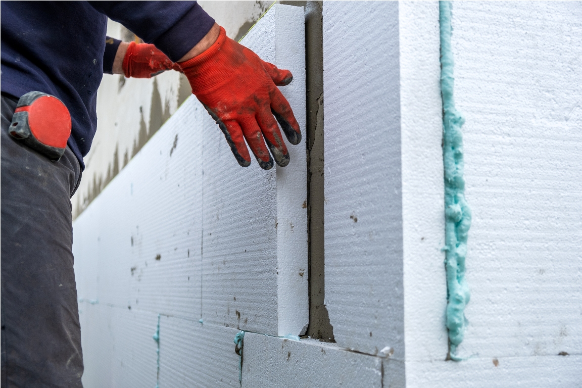 construction worker installing styrofoam insulatio 2022 07 15 18 10 56 utc