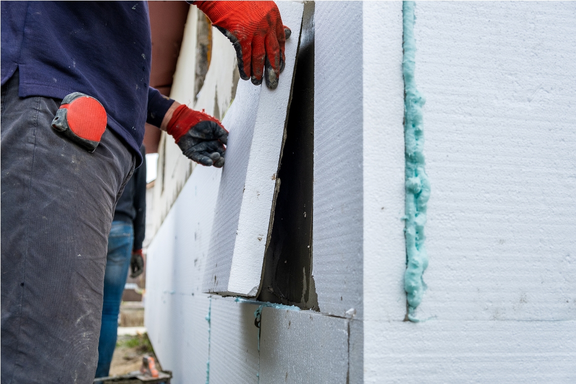 construction worker installing styrofoam insulatio 2023 08 26 09 25 13 utc