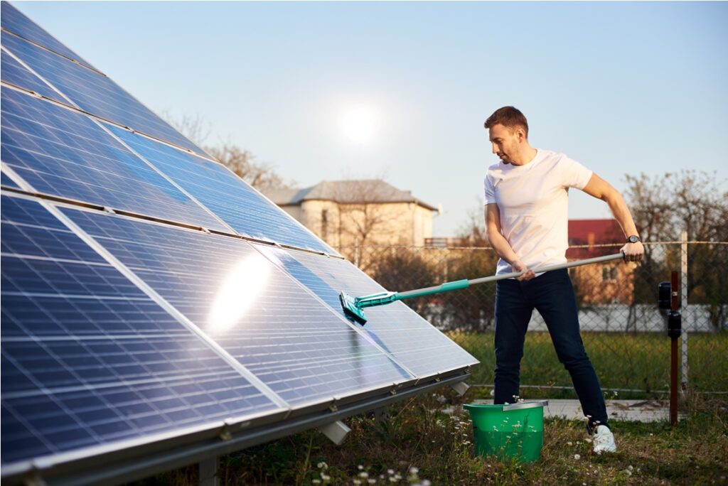 young man cleaning solar panel 2022 05 20 20 34 58 utc