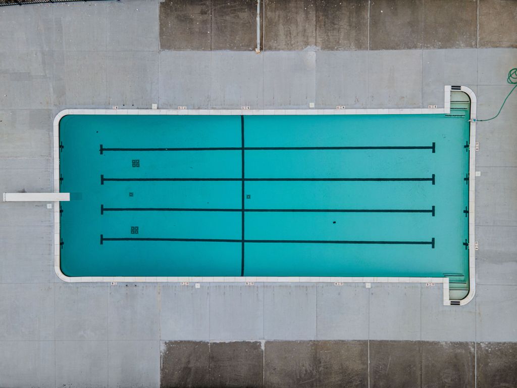 an aerial top view of an empty swimming pool