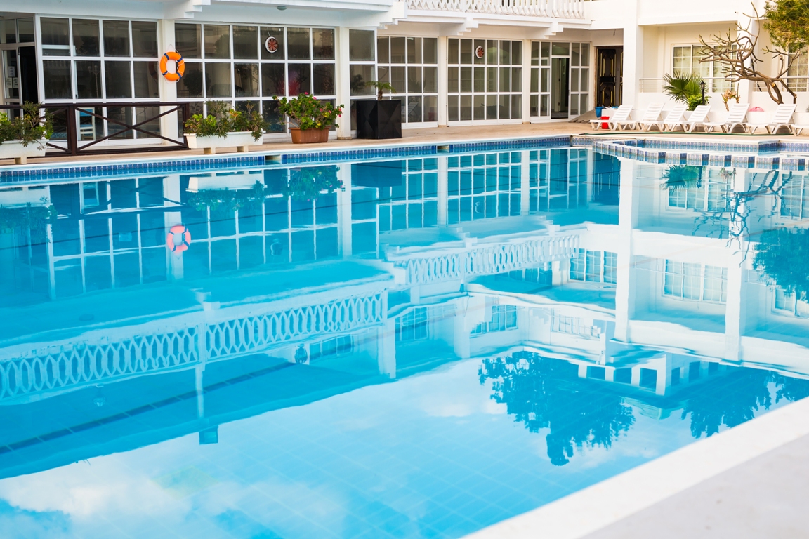 swimming pool of luxury hotel. swimming pool in hotel with metal ladder.