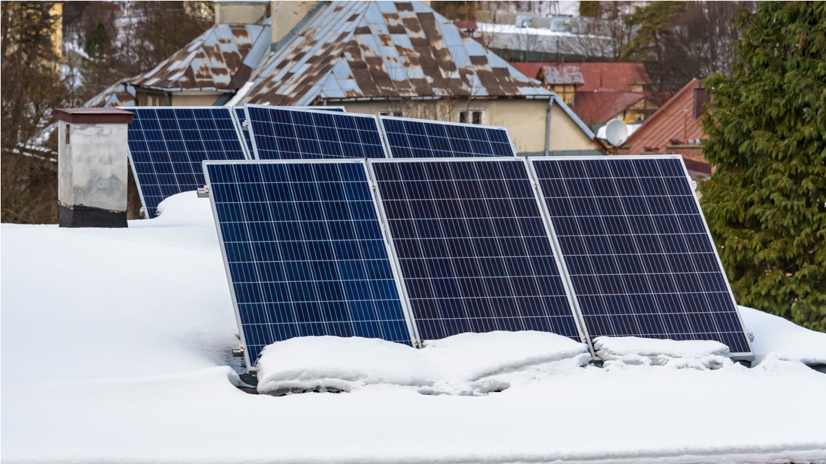 solar panels of photovoltaic power plant on the snow covered roof