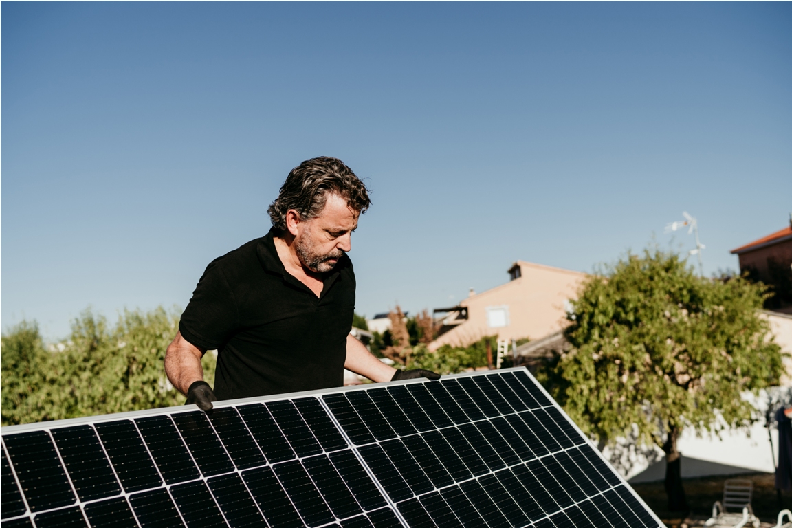 technician holding solar panels on house roof for 2023 11 27 05 08 25 utc