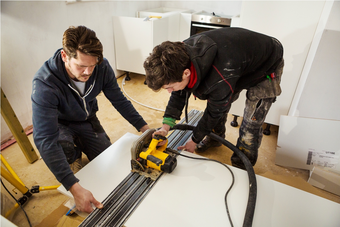 two builders cutting plasterboard with a circular 2023 11 27 05 22 48 utc