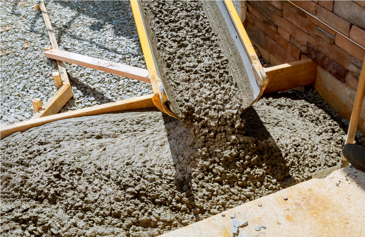 pouring cement during paving concrete pavement near the driveway