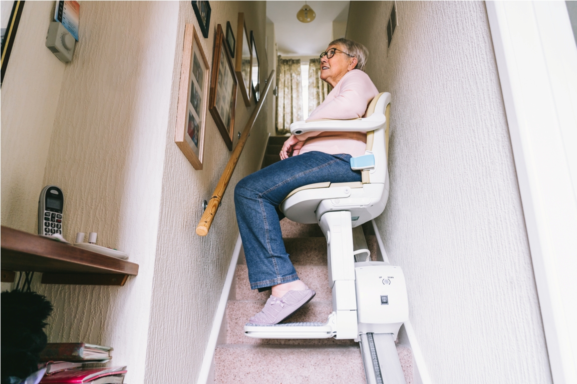senior woman using automatic stairlift on a stairc 2023 11 27 05 10 36 utc